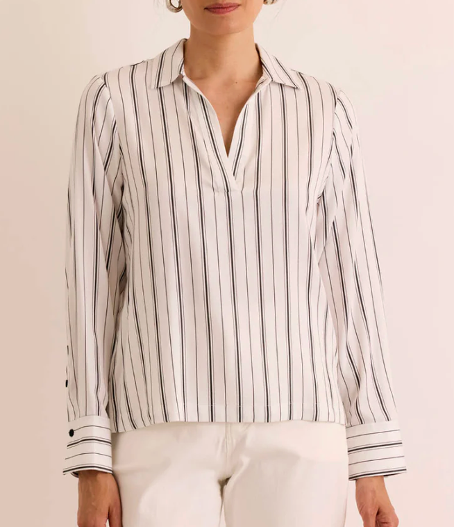 Hinson Wu Long Sleeve Mona Top in ivory and black Tencel stripe, styled with an open point collar and V-neckline, worn with white trousers and gold hoop earrings, shown against a neutral backdrop.