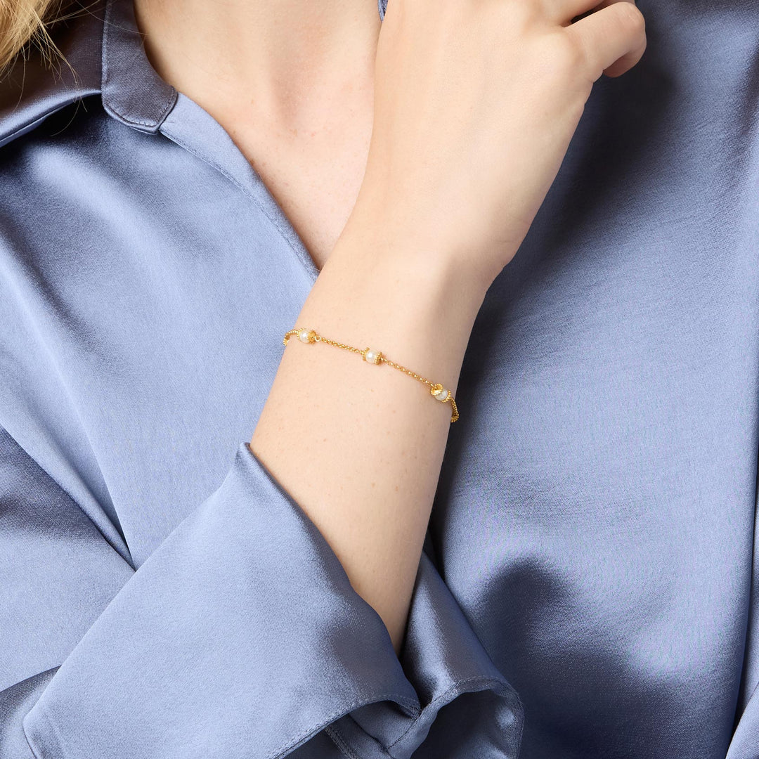 Julie Vos Hydra Delicate Bracelet worn on wrist, shell pearl spheres with beaded gold caps along Venetian box chain