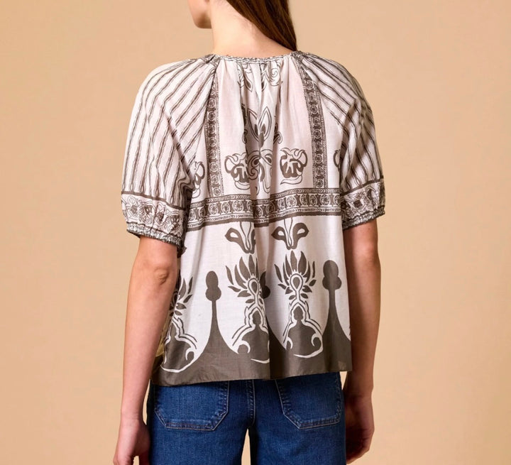 Back of Cleobella Johana Blouse in sable, relaxed V-neck border-print top with tassel tie and elasticated raglan sleeves