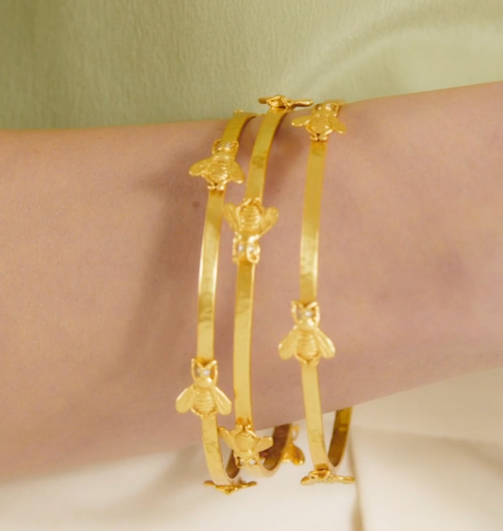 Julie Vos Bee Bangle, on-model detail worn in a stack of three, close-up of bee stations with CZ eyes