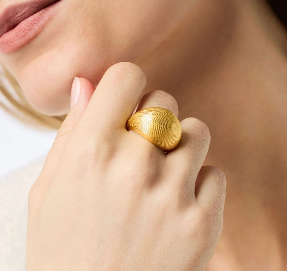 Julie Vos Cobblestone Bombe Ring, on-model close-up worn on finger near collarbone, showing scale and texture detail.