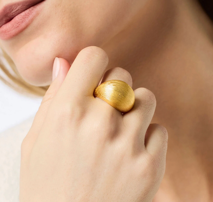 Julie Vos Cobblestone Bombe Ring, on-model close-up worn on finger near collarbone, showing scale and texture detail.