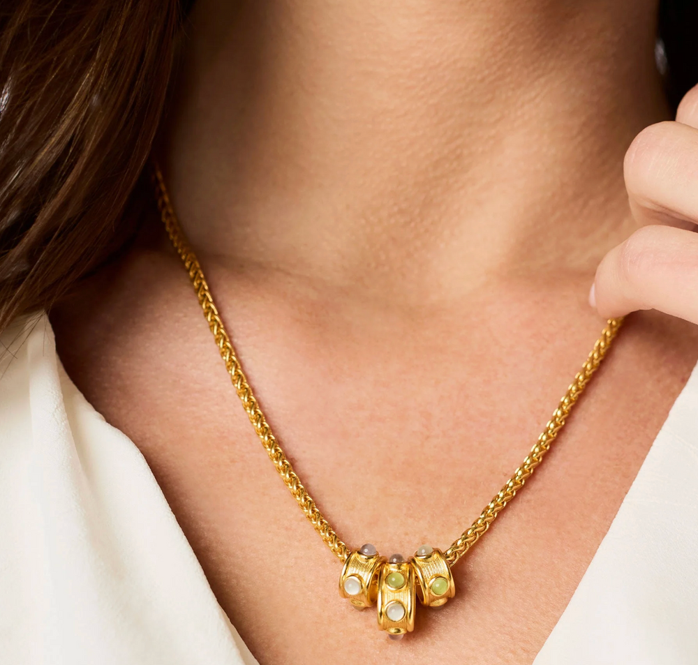 Julie Vos Cobblestone Loop Necklace, on-model close-up worn at the neckline, showing cabochon cluster detail against skin.