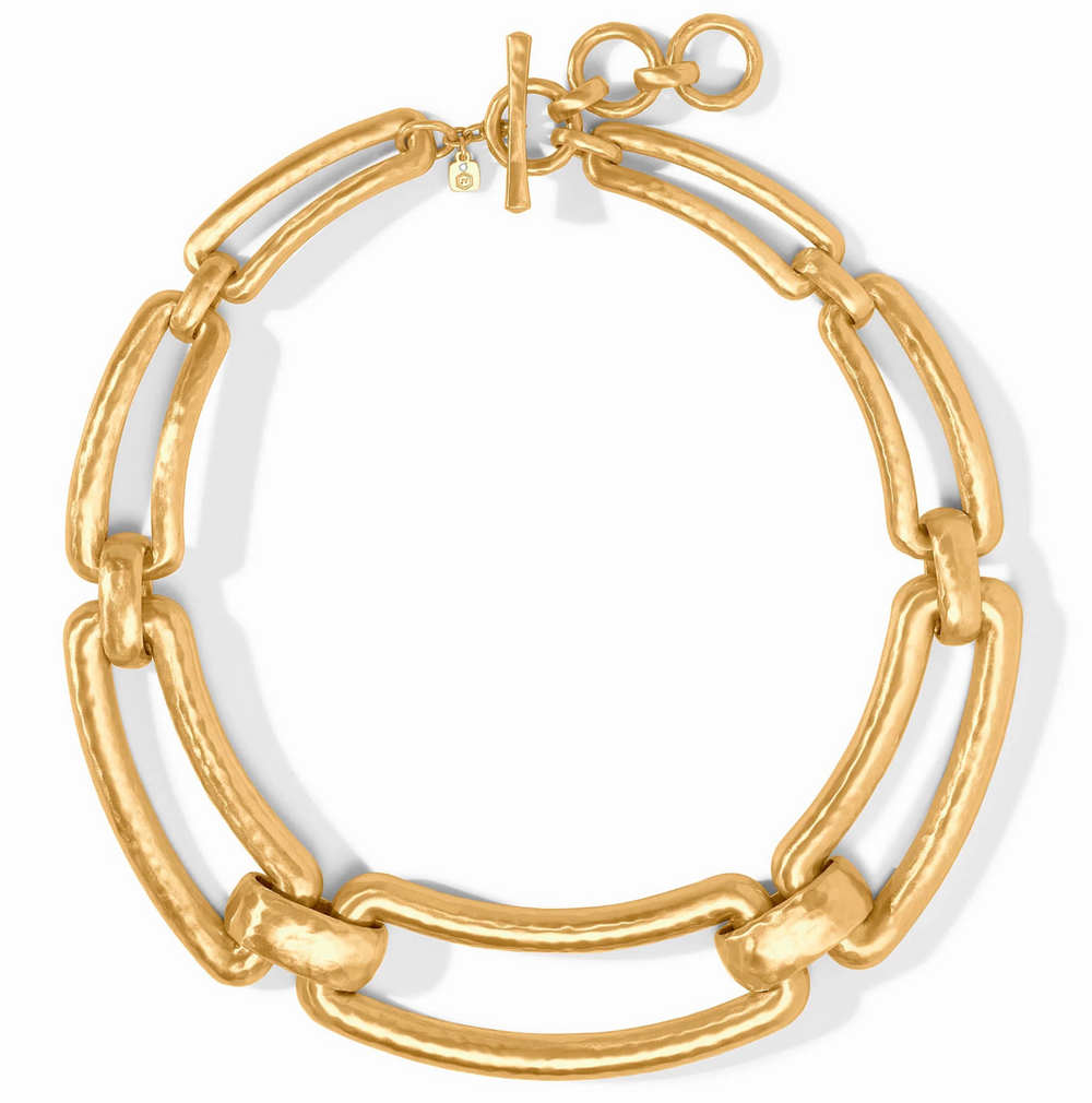 Full flat-lay view of the Sahara Collar Necklace in 24K gold plate on a white background, showing the alternating link design and toggle clasp.