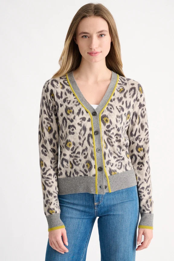 Woman wearing an agate leopard print cashmere cardigan with grey and chartreuse trim, front view.