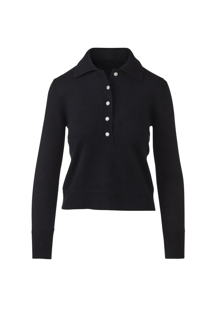 Flat lay of a black cashmere polo sweater with crystal buttons and ribbed cuffs.