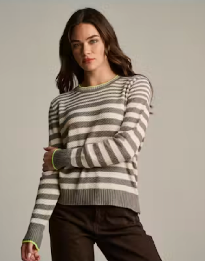 Lisa Todd Stripe Idol Sweater — front view, model wearing striped crew neck sweater with neon contrast trim, arms crossed, styled with dark brown denim.