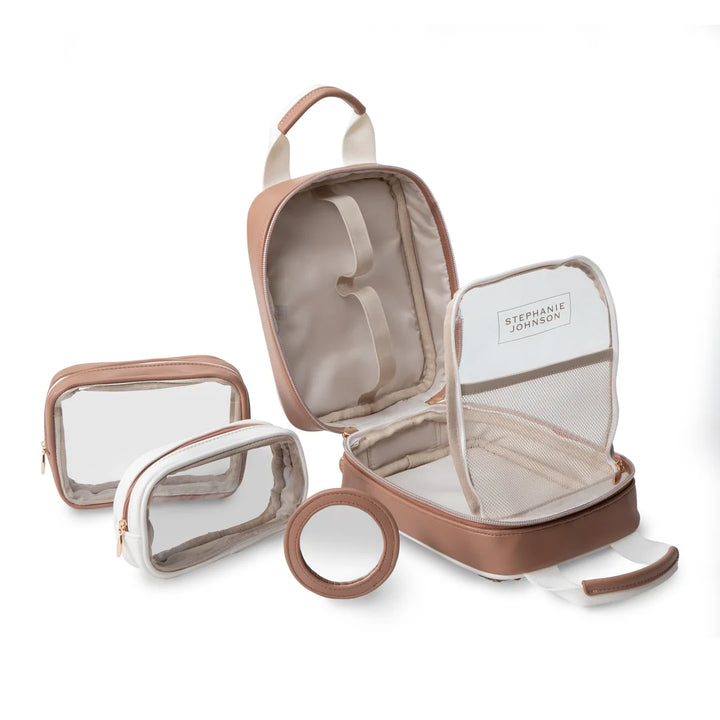 Flat lay with components: Stephanie Johnson Sasha Travel Bag open beside its two coordinating pouches (one clear, one solid with clear front) and round mirror compact, showing the full travel organization set.