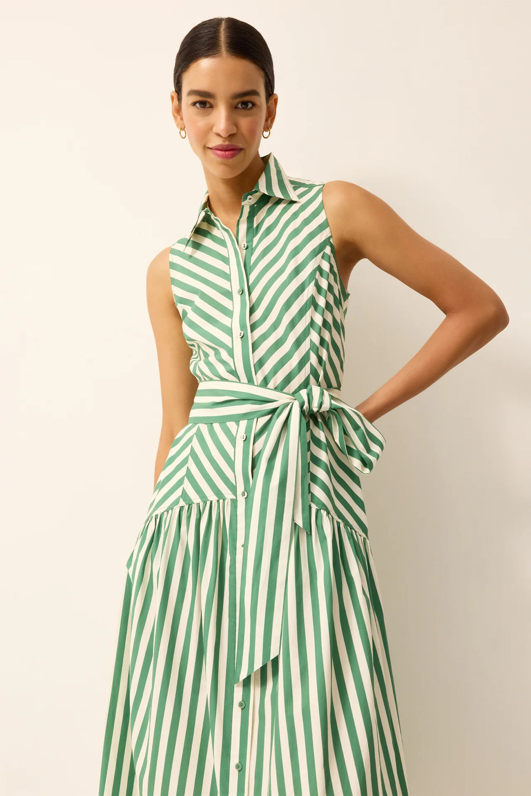 Close-up of Marie Oliver Adalyn Dress bodice, showing button-up placket, collar, and sash belt tie in green-and-white stripe.