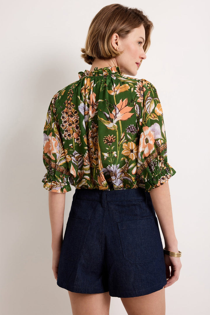 Marie Oliver Billie Blouse in Greenhouse — back view styled with dark-wash denim shorts