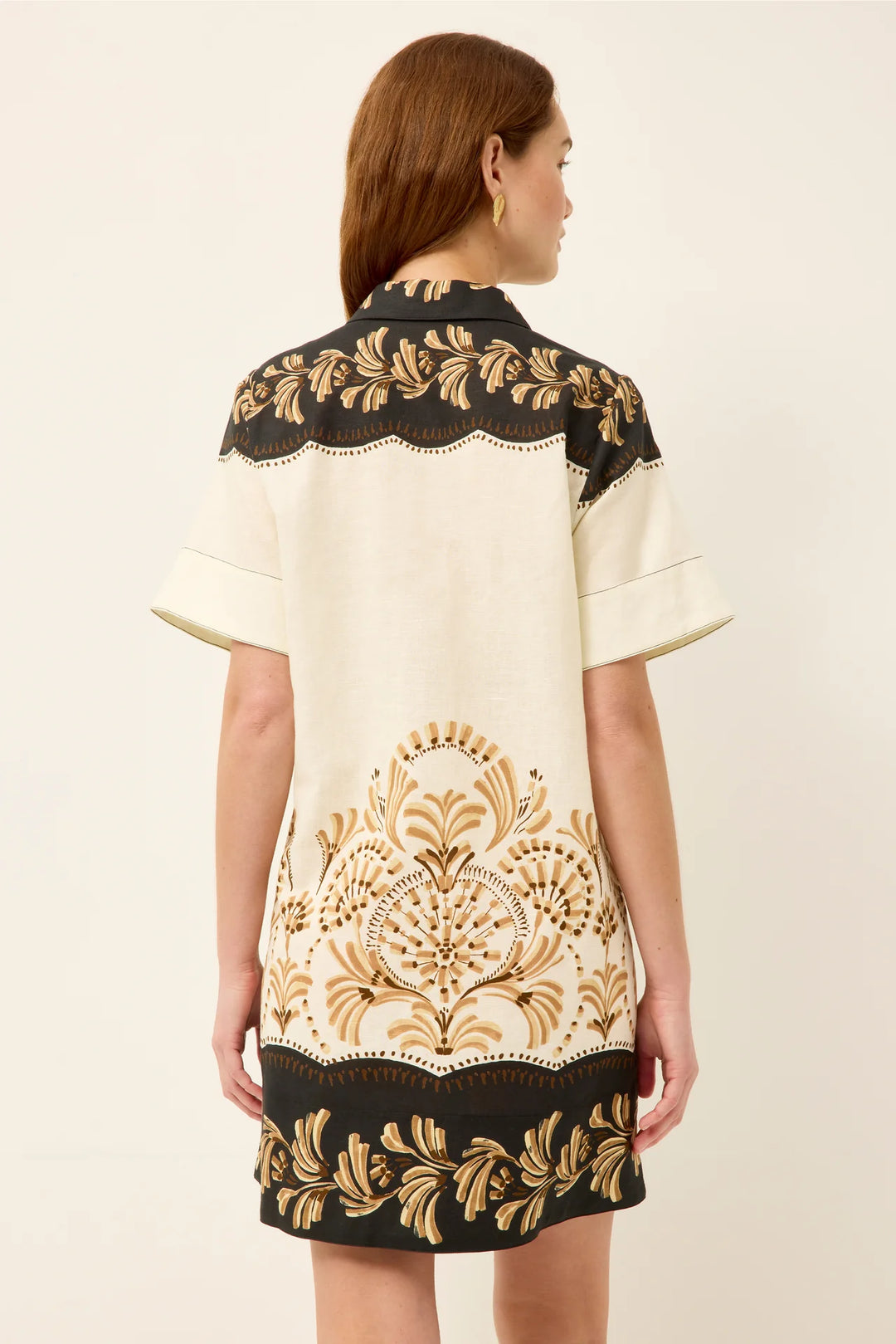 Marie Oliver Dede Dress in Fleuron — back view showing mirrored placement print, polo collar, clean-finished short sleeves, and dark hem border detail.