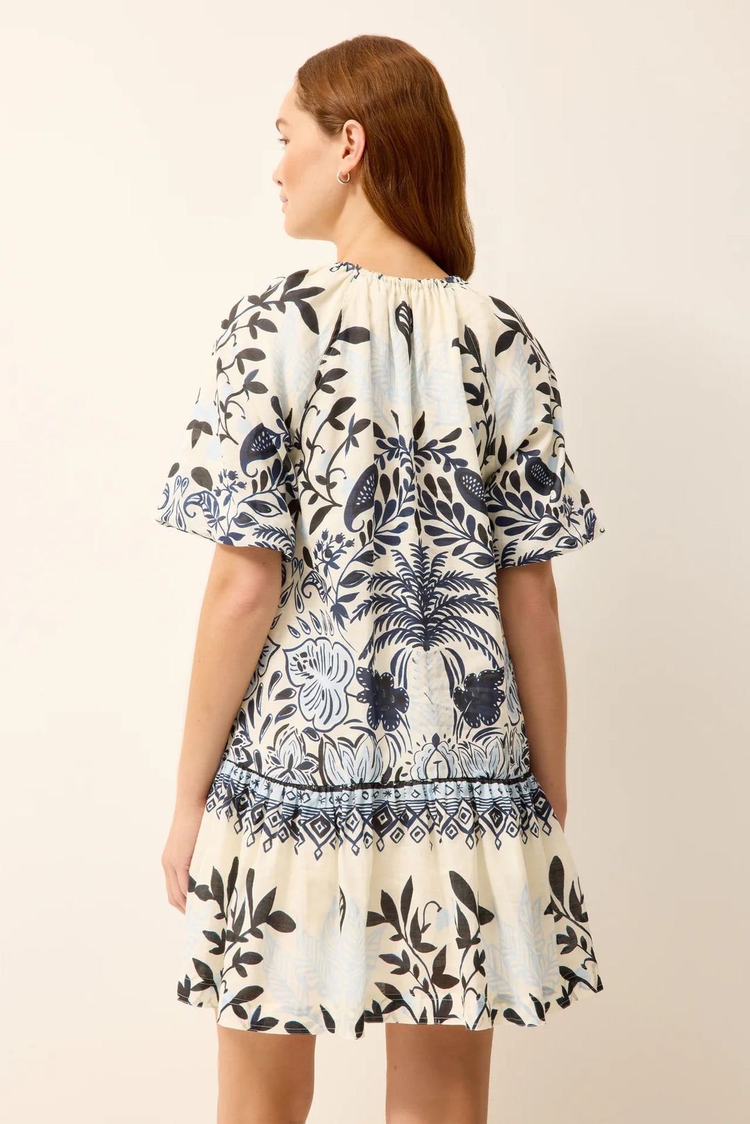 Marie Oliver Greta Dress, back view showing raglan seam construction and drop-waist A-line shape in Tropica print.