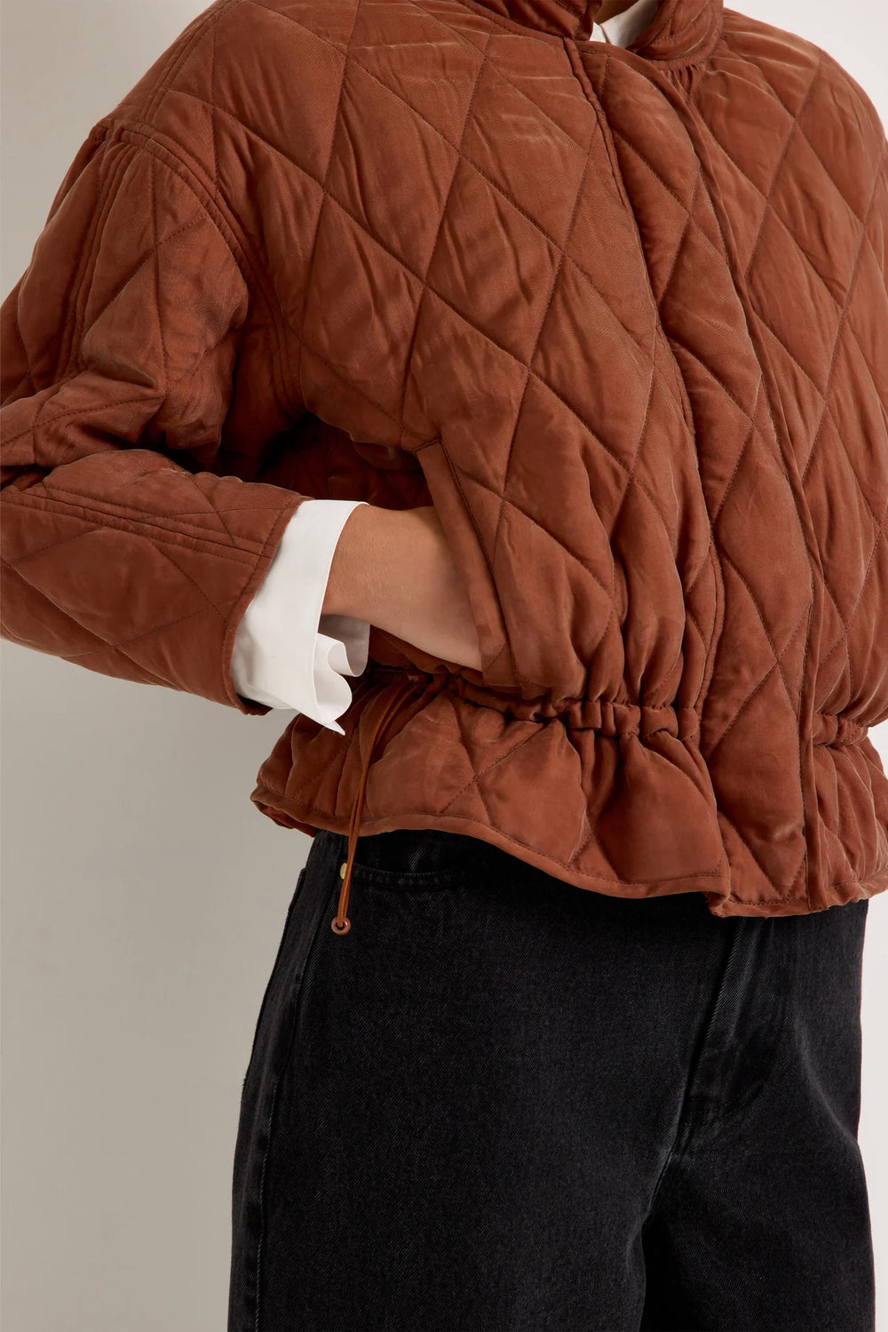 Marie Oliver Haisley Jacket in Tortoise, detail close-up of cinched drawstring waist with cord stopper, side pocket, and peplum-style hem