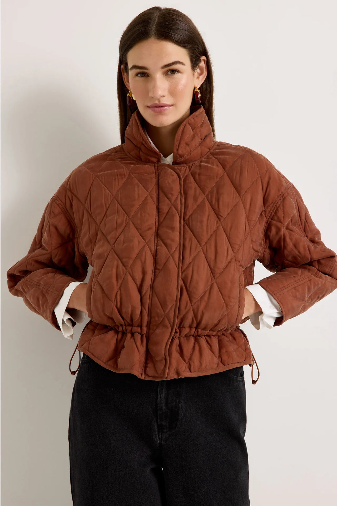 Marie Oliver Haisley Jacket in Tortoise, front view on model, fully closed with funnel neck standing and waist drawn in