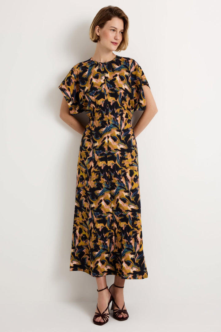 Marie Oliver Kamari Dress, Mellow print, front view, model wearing full-length maxi with flutter sleeves and hands behind back.