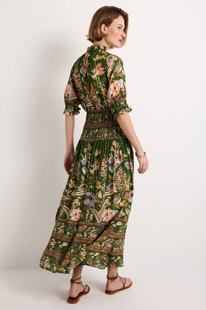 Marie Oliver Stacie Skirt, Greenhouse floral print, back three-quarter view, styled as a dress with short sleeves and gold bangles.