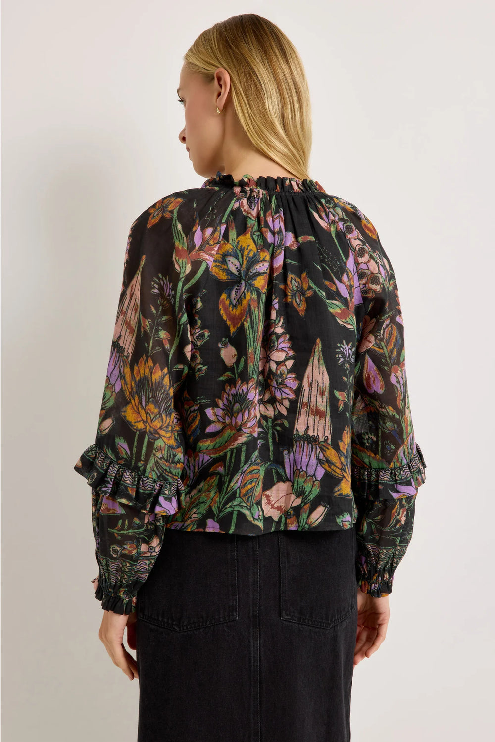 Marie Oliver Umika Top in Nightshade, back view on model, showing the gathered ruffle neckline, relaxed body, and sleeve ruffles with geometric border bands