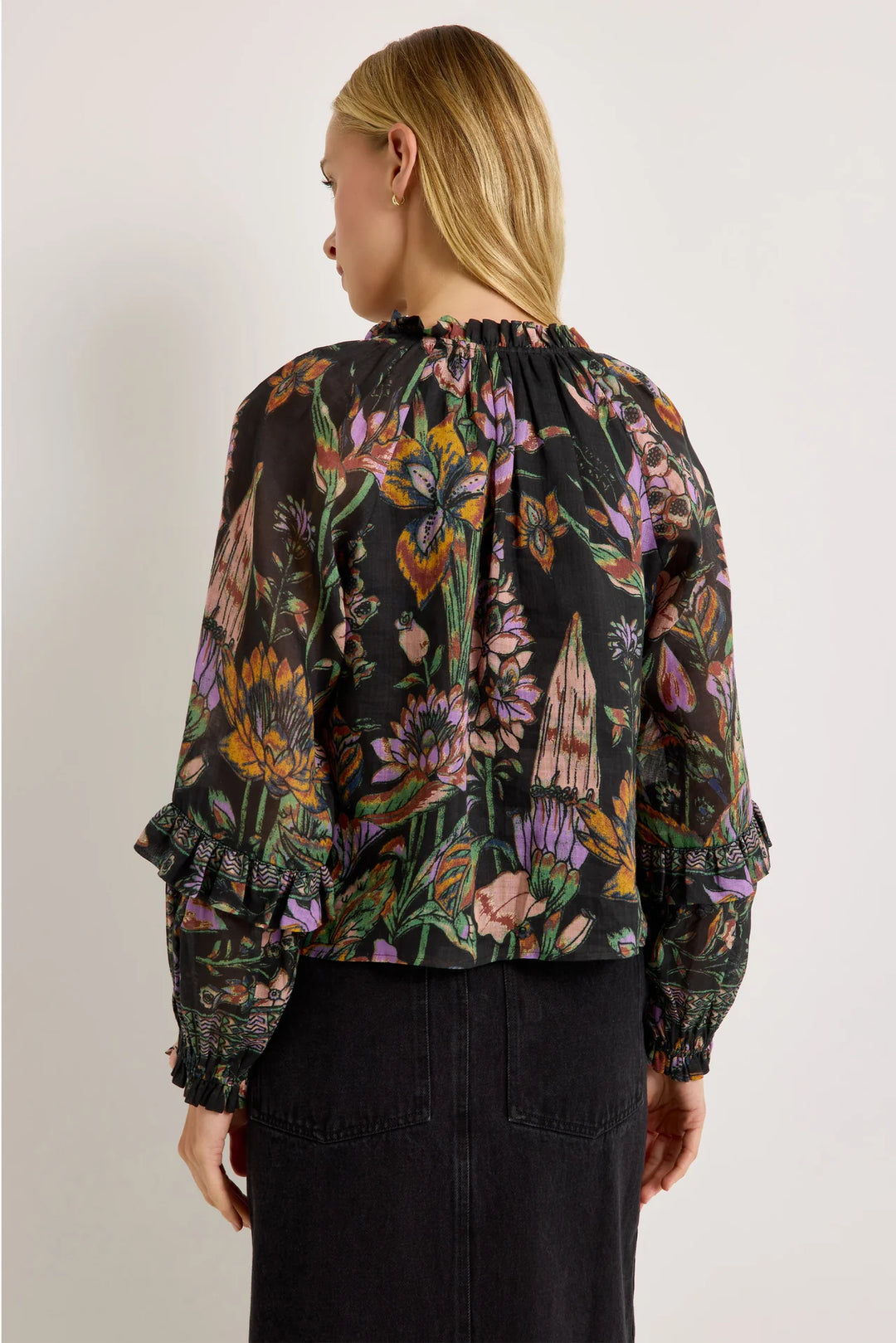 Marie Oliver Umika Top in Nightshade, back view on model, showing the gathered ruffle neckline, relaxed body, and sleeve ruffles with geometric border bands