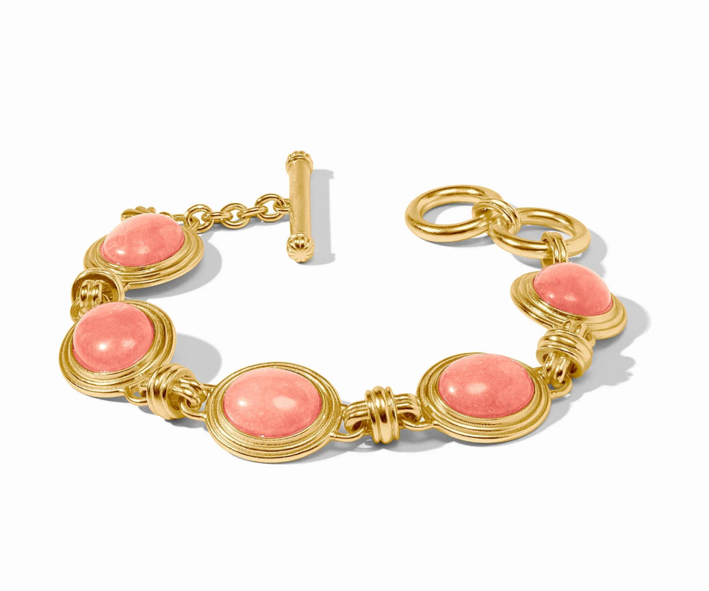 Gold bracelet with pink stones on a white background
