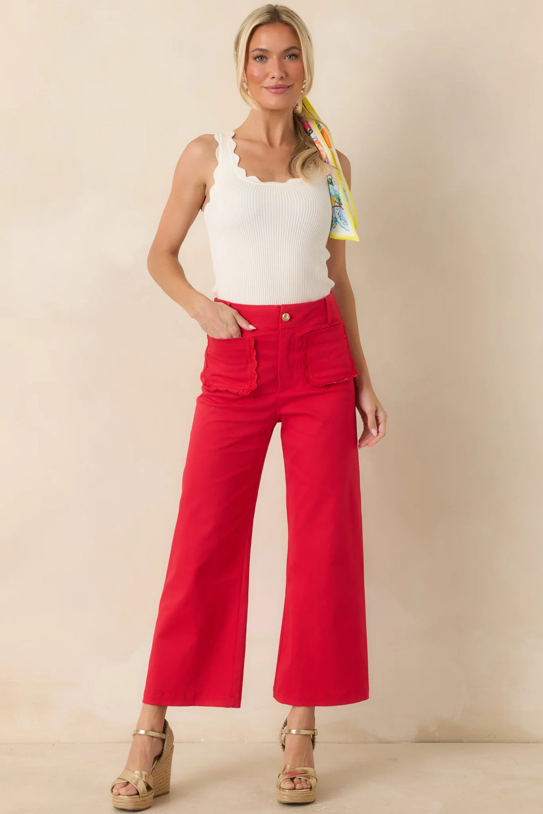 Prosperina Miller Cherry Red Cotton Scalloped Pocket Pants, high-rise cropped wide-leg silhouette with oversized scalloped front patch pockets, shown on model facing forward.
