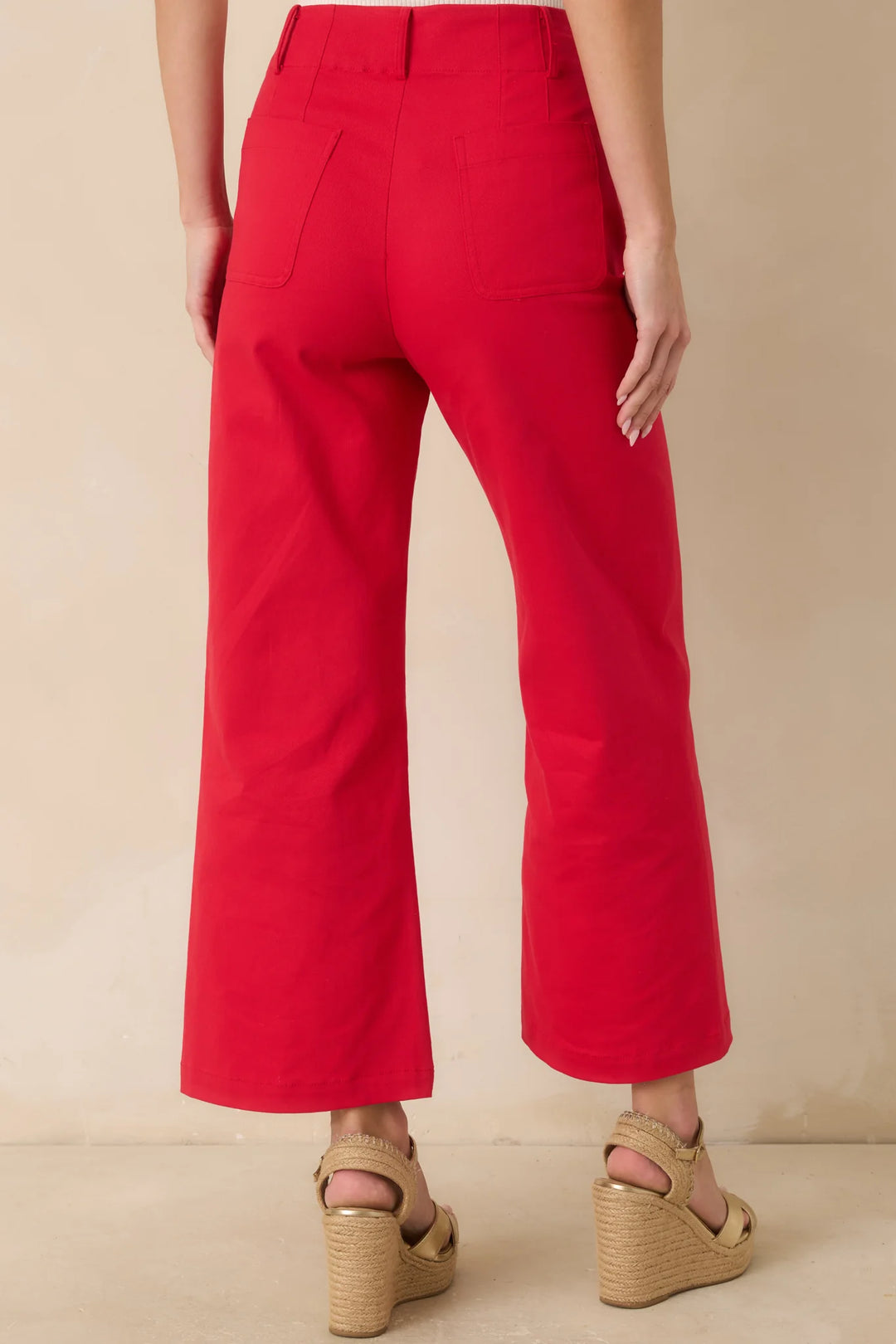 Prosperina Miller Pants, back view showing functional back pockets and cropped wide-leg shape in cherry red cotton.