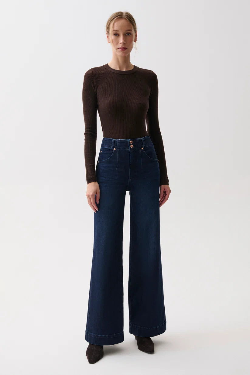 Front view, woman in brown ribbed sweater and Pistola Lana dark wash wide-leg jeans with double-button waist, standing.