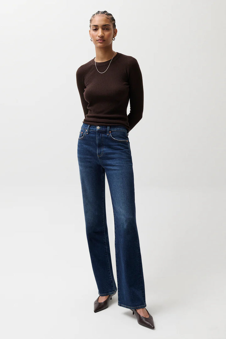 Pistola Evie High Rise Slim Boot Jean in Penthouse, dark indigo denim, high rise slim boot silhouette, full-length front view styled with fitted brown ribbed top and kitten heels