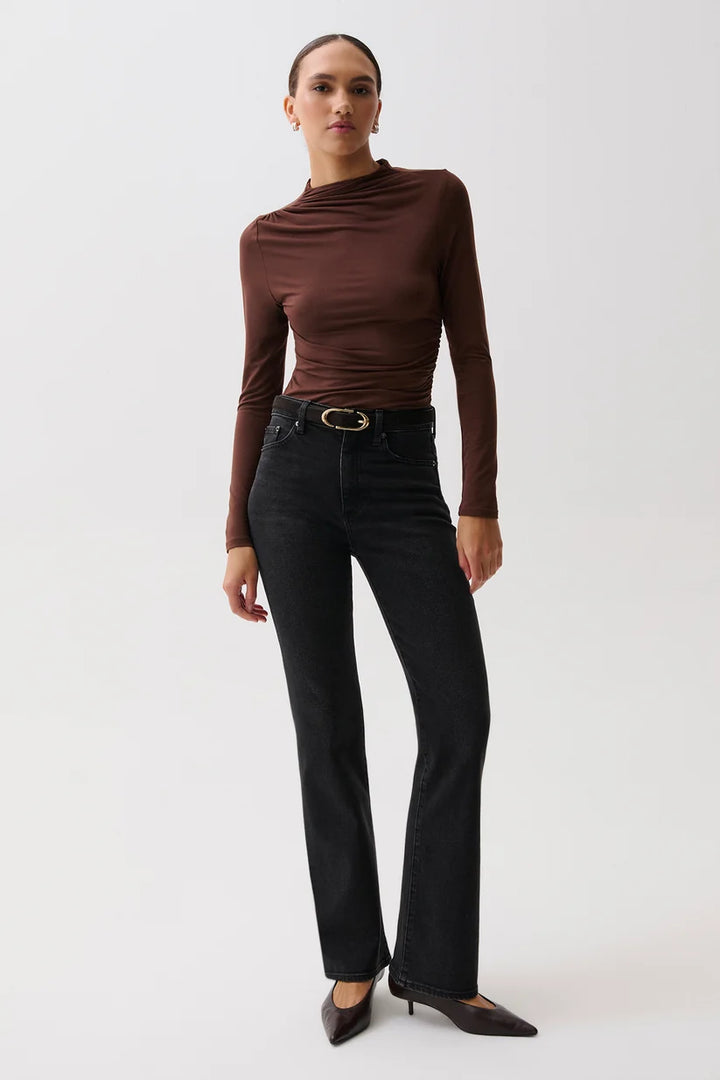 Pistola Evie High Rise Slim Boot in Jetset, full-length front view on model, showing high rise with gold-buckle belt, slim thigh, and subtle bootcut flare over pointed kitten heels.