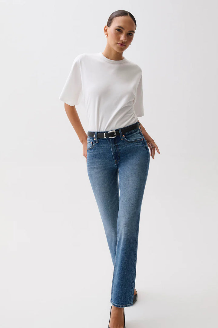 Front on-model, hand on hip — Pistola Aleks Mid Rise Straight Long Jean in Sea Salt, medium wash straight leg denim