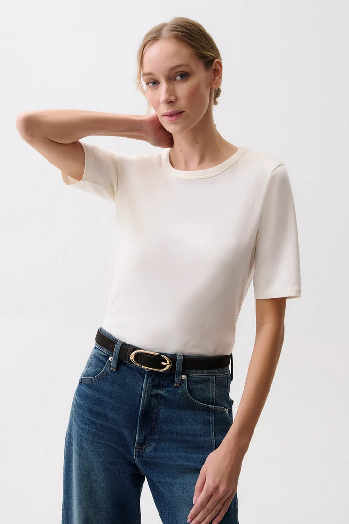 Pistola Melika Quarter Sleeve Crew Neck Tee Closeup in Soft White, front view, model wearing ivory crewneck tee with dark wash wide-leg jeans and belt.