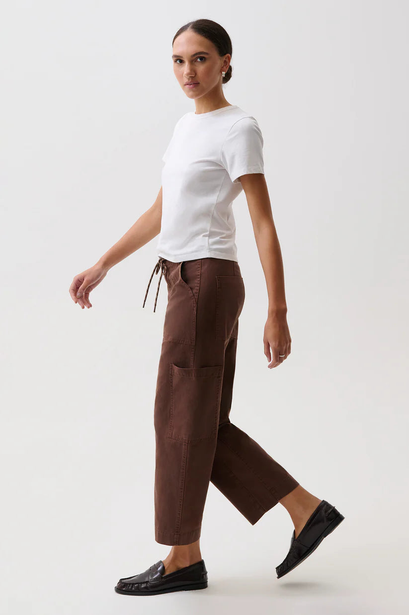 Side on-model, walking — Pistola Sabrina Curved Utility Pants in Lindt, curved leg silhouette and cargo pocket detail