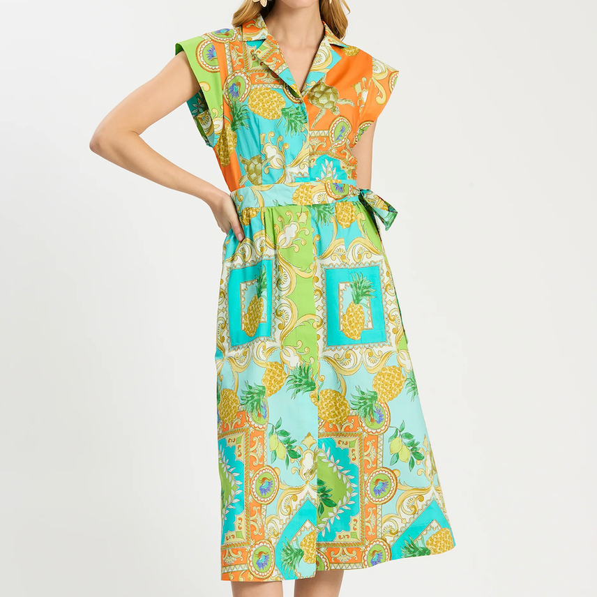 Colorful patterned dress worn by a model on a white background