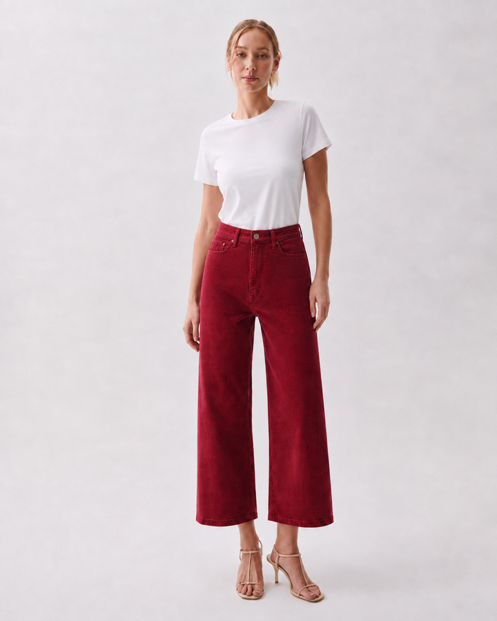 Pistola Penny Crop High Rise Wide Leg Corduroy in Deep Crimson, front view, model wearing crimson wide-leg cropped corduroy pants with white tee and nude heels.