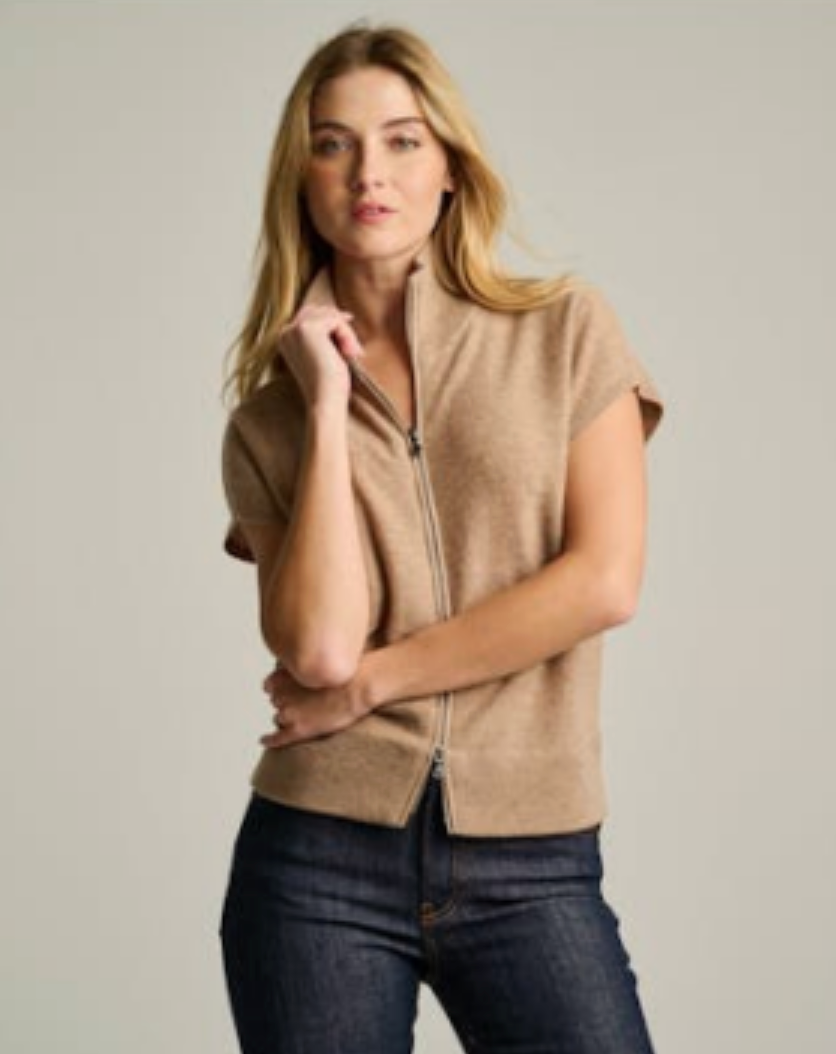Biscuit cashmere zip vest with cap sleeves and stand collar, worn with dark denim