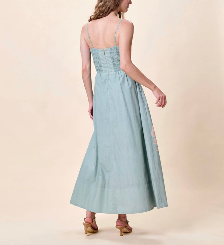 Back of Cleobella Riley Ankle Dress in Moresco Blue Surf, square neck with adjustable straps and large-scale orchid placement print