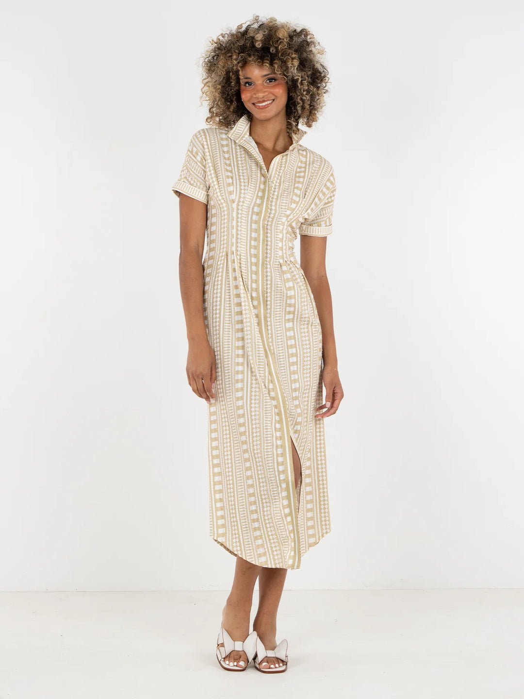 Emily McCarthy Georgia Dress in Piazza Stripe, sand and white geometric stripe cotton midi with stand collar, front button placket, and dolman sleeves, shown with white sandals.