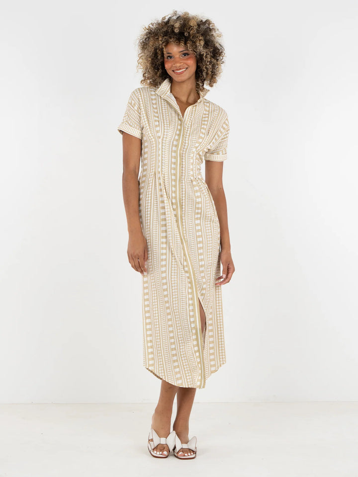 Emily McCarthy Georgia Dress in Piazza Stripe, sand and white geometric stripe cotton midi with stand collar, front button placket, and dolman sleeves, shown with white sandals.