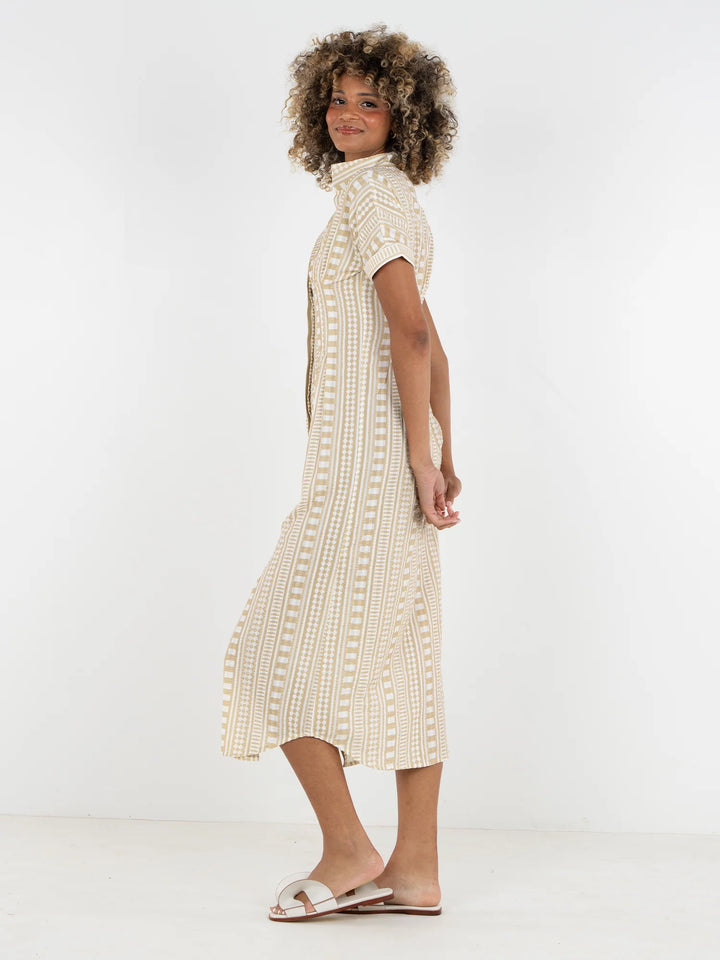 Side view of Emily McCarthy Georgia Dress in Piazza Stripe showing fitted waist, curved hem, and full midi skirt with movement.