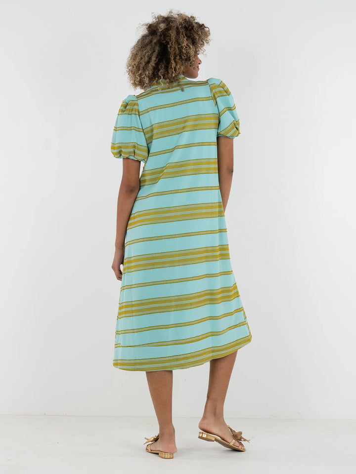 Back view of Emily McCarthy Hampton Dress in Fringe Stripe showing A-line midi silhouette and elastic puff sleeve detail in aqua and chartreuse stripe.