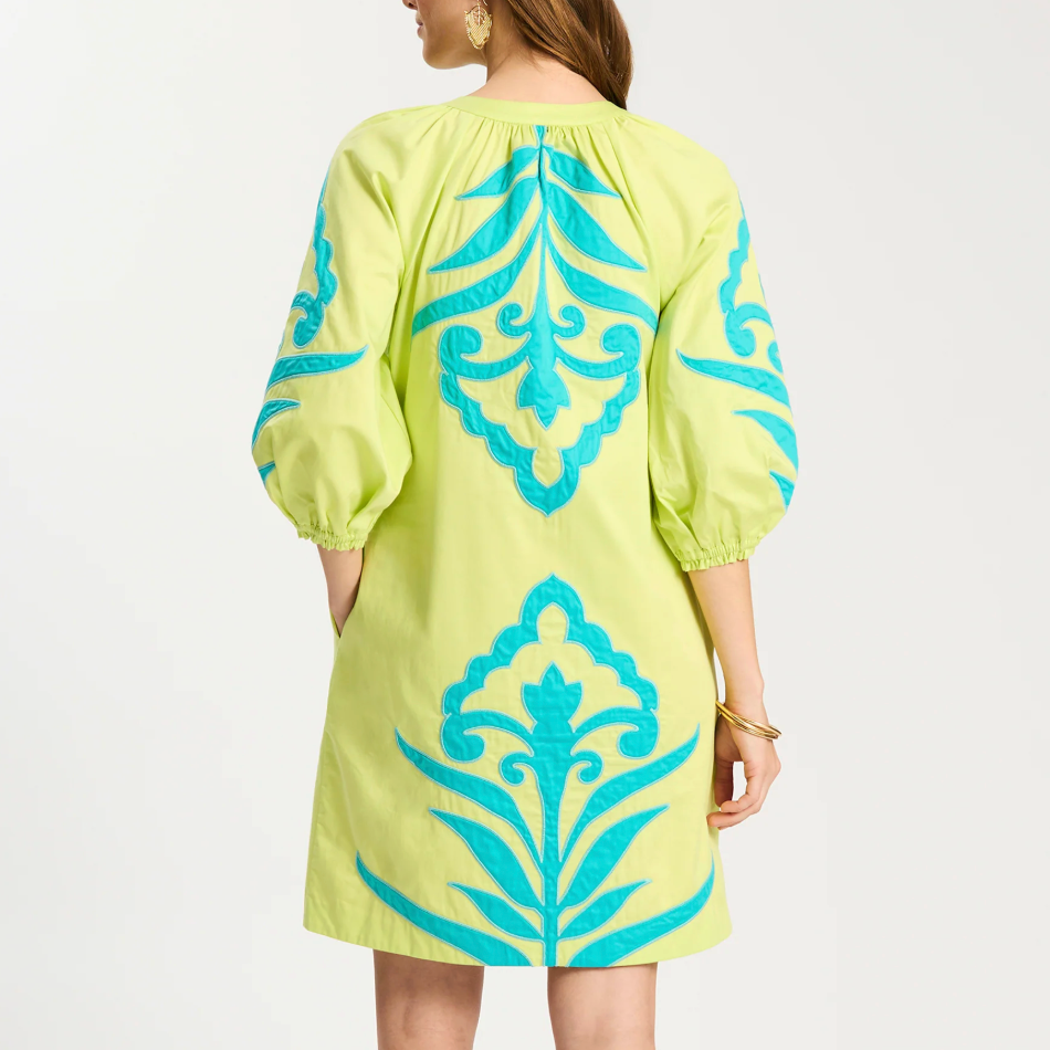Lime dress with blue patterns on a white background