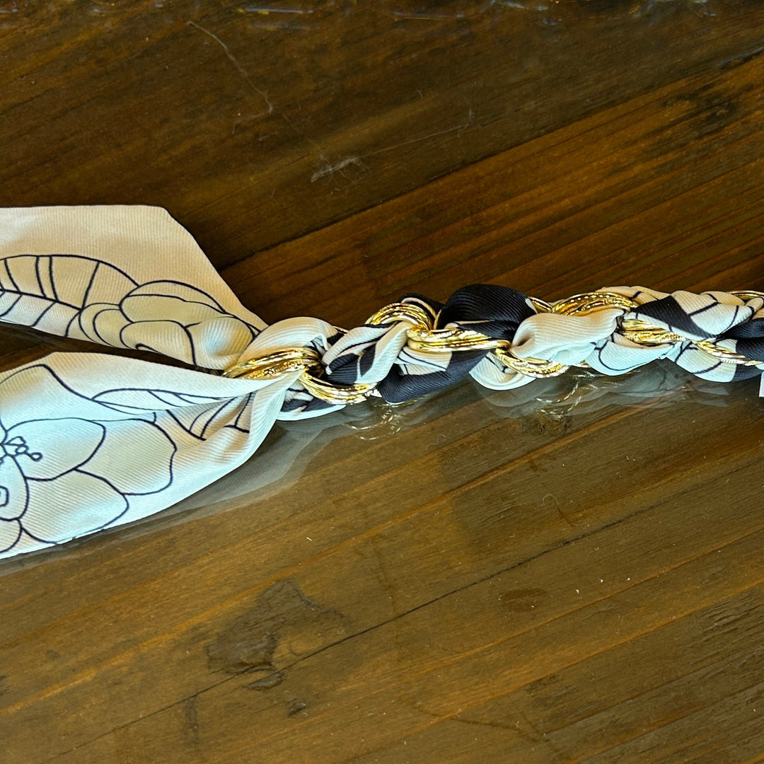 Gold chain with a tag on a wooden surface