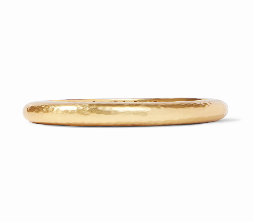 Julie Vos Catalina Hinge Bangle in 24K gold plate — smooth hammered oval band with engraved interior detailing and spring-hinge closure, shown standing upright on white background.