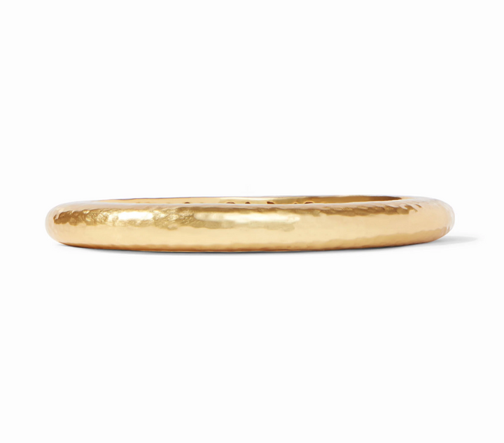 Julie Vos Catalina Hinge Bangle in 24K gold plate — smooth hammered oval band with engraved interior detailing and spring-hinge closure, shown standing upright on white background.