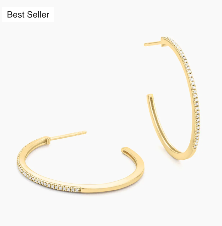 Ella Stein A Hoop Thing Medium Hoop Earrings in gold — angled flat lay of pair showing slim profile, squared-bottom hoop silhouette, and continuous pavé diamond setting along outer curve.
