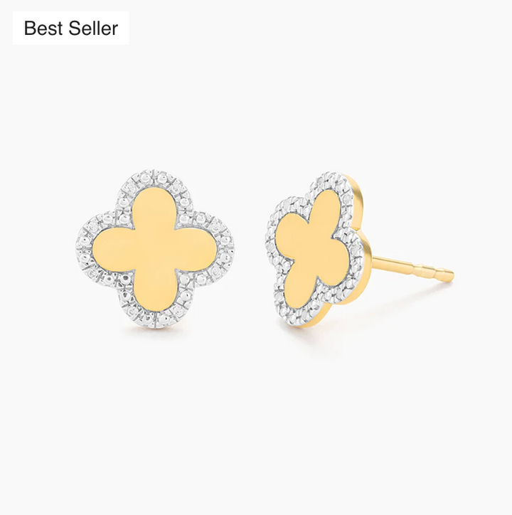 Ella Stein Classic Bloom Clover Stud Earrings in gold — angled flat lay pair showing four-petal clover silhouette with polished gold center and pavé natural diamond border, post back closure visible.