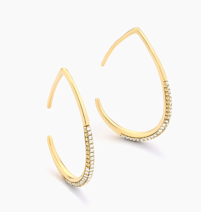 Ella Stein Drop By Anytime Hoop Earrings in gold — angled flat lay pair showing full geometric teardrop shape, smooth upper arc, and pavé diamond base in gold plating.