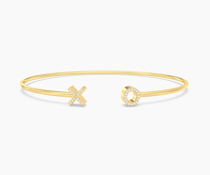 Ella Stein XO Flexi Cuff Bracelet in gold — front flat lay showing open wire cuff with pavé natural diamond X and O terminals at each end in gold plating.