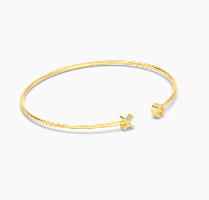 Ella Stein XO Flexi Cuff Bracelet in gold — angled flat lay showing dimensional X and O terminal construction, pavé diamond setting, and open cuff profile in gold plating.