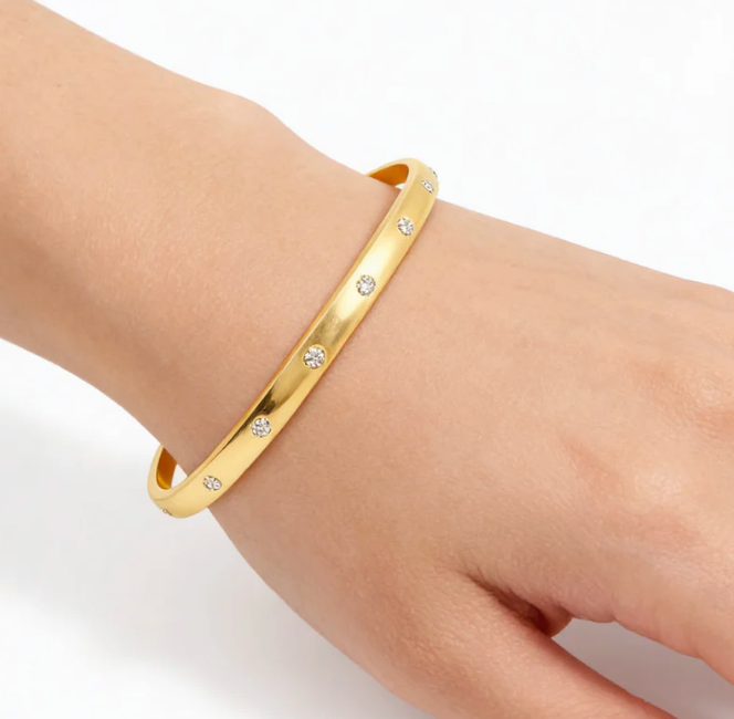 Ella Stein Lucky 7 Cuff Bracelet in gold — close-up wrist shot showing cuff width, bezel-set diamond stations, polished band surface, and open cuff fit in gold plating.