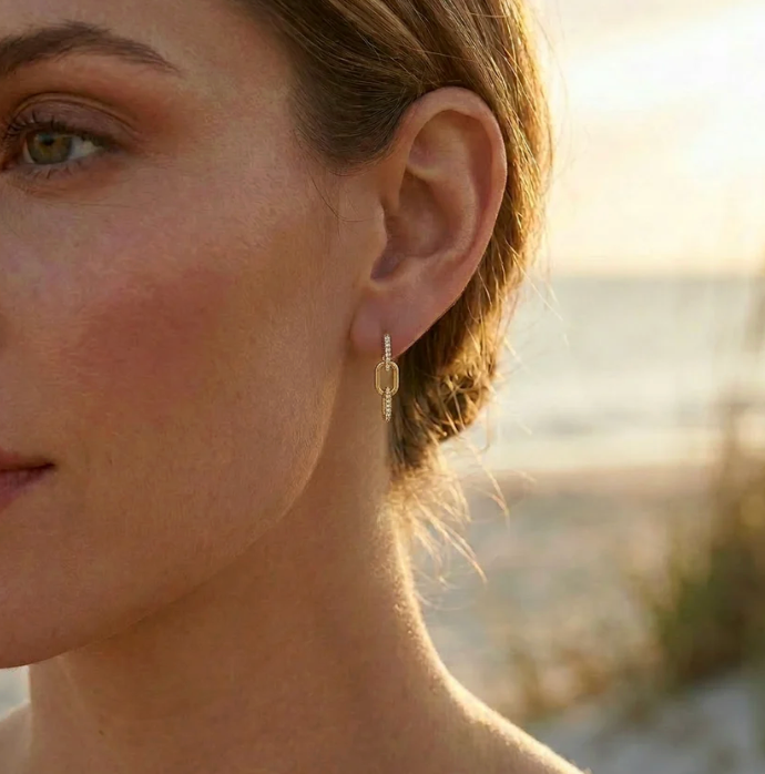 Ella Stein Trio Link Drop Earrings in gold — close-up lifestyle shot on model at golden hour showing drop length at ear, link movement, and pavé diamond detail catching warm light.
